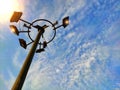 Electric lamp or mast post very high in hight against blue sky used for illumination roads during night Royalty Free Stock Photo