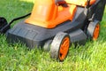 Electric lawnmower on green grass Royalty Free Stock Photo