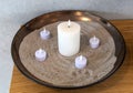 Electric, Led candles in sand in a large bowl. Royalty Free Stock Photo