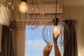 Electric LED Lightbulb Change In Light At Home. woman changing lightbulb in a lamp. Royalty Free Stock Photo