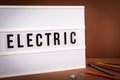 Electric. Light box with text on a brown office desk Royalty Free Stock Photo