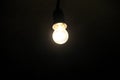 Electric light bulb on dark background Royalty Free Stock Photo