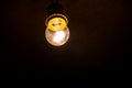 Electric light bulb on dark background Royalty Free Stock Photo