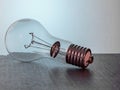 Electric light bulb, old technology, on a table with a large base for industrial use, close-up.