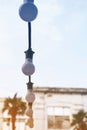 Electric light bulbs hangs on a cord against the sky