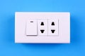 Electric light switch on blue background Royalty Free Stock Photo