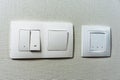 Electric light switch and socket on the empty wall, electrical power socket and plug switched. Comfort house. Off sensor for floor