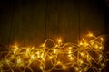 Electric lighted on wooden background Christmas rustic background - vintage planked wood with lights and free text space.