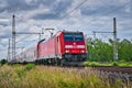 Electric locomotive driving over the railway tracks surrounded by trees in Dedensen Guemmer, Germany