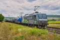 Electric locomotive pulling a tank car train through the Main valley, Retzbach Zellingen, Germany