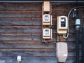 Electric measuring power meter installed on the wooden wall vintage home Royalty Free Stock Photo