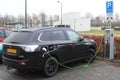 Modern electric plug car Mitsubishi Outlander charges new electric energy, Netherlands Royalty Free Stock Photo