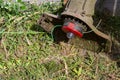 An electric mower on the grass.