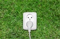 Electric outlet on green grass Royalty Free Stock Photo