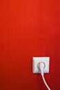 Electric outlet on red wall Royalty Free Stock Photo