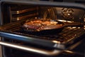 electric oven with a cast iron skillet and sizzling steak inside