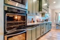 Electric oven and microwave inside a modern home kitchen with built in cabinets Royalty Free Stock Photo