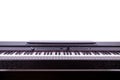 An electric piano on a white background, showing the modern piano keys on a white wall Royalty Free Stock Photo