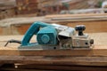 Electric planer on the wooden plank in carpentry workshop Royalty Free Stock Photo