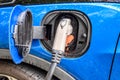 Electric plug of charging station connected to a vehicle for battery recharge