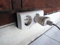 Electric plug on house wall Royalty Free Stock Photo