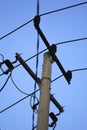Electric pole against the background of a clear blue sky Royalty Free Stock Photo