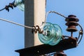 Electric pole against the blue clear sky. Three-phase power line to turn Royalty Free Stock Photo