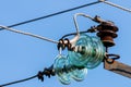 Electric pole against the blue clear sky. Three-phase power line to turn Royalty Free Stock Photo