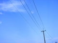 Electric pole, blue sky and white clouds. Royalty Free Stock Photo