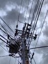 electric pole with a complicated string of wires on the side of the highway