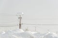 Electric pole covered with a lot of snow in the winter Royalty Free Stock Photo