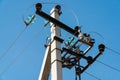 Electric pole. Electrical post with power line cables. Power lines and wires against bright blue sky Royalty Free Stock Photo