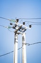 Electric pole with high-voltage wires against the blue sky Royalty Free Stock Photo