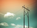 Electric pole and power cables on red and green sky with white clouds backgrounds Royalty Free Stock Photo