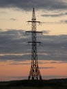 Electric pole, tower, against the background of evening clouds Royalty Free Stock Photo