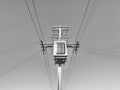 An electric pole with a transformer. Monochrome photo. Royalty Free Stock Photo
