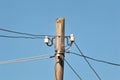 Electric pole with wires on a sunny day Royalty Free Stock Photo