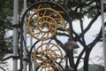 electric poles lined with street lamps with circular patterns and shapes and painted in golden color