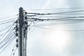 Electric poles with many wires leading under the sky.