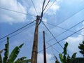 electric poles standing tall against the bright blue sky background Royalty Free Stock Photo