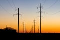 electric poles,wires against the sunset sky. Royalty Free Stock Photo