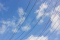 Electric power cables against blue cloudy sky with copy space Royalty Free Stock Photo