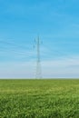 Electric power distribution, electricity power line pylons in countryside fields Royalty Free Stock Photo