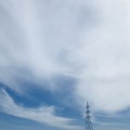 An Electric power high voltage transmission line tower with big blue sky. Square photo image. Royalty Free Stock Photo