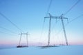 Power lines in snow field at pastel sunset Royalty Free Stock Photo