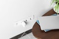 Electric power outlet sockets with charger on white wall Royalty Free Stock Photo