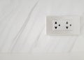 Electric power plug with white cover with mable wall.