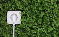 Electric power receptacle on a green grass background Royalty Free Stock Photo