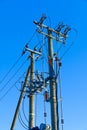 electric power sky lines and connections on a wooden post. wooden electricity post against blue sky. Electric power lines and Royalty Free Stock Photo