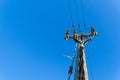 electric power sky lines and connections on a wooden post. wooden electricity post against blue sky. Electric power lines and Royalty Free Stock Photo